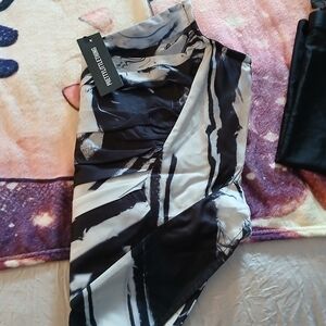 Crop top zipper in the back black and white and gray .